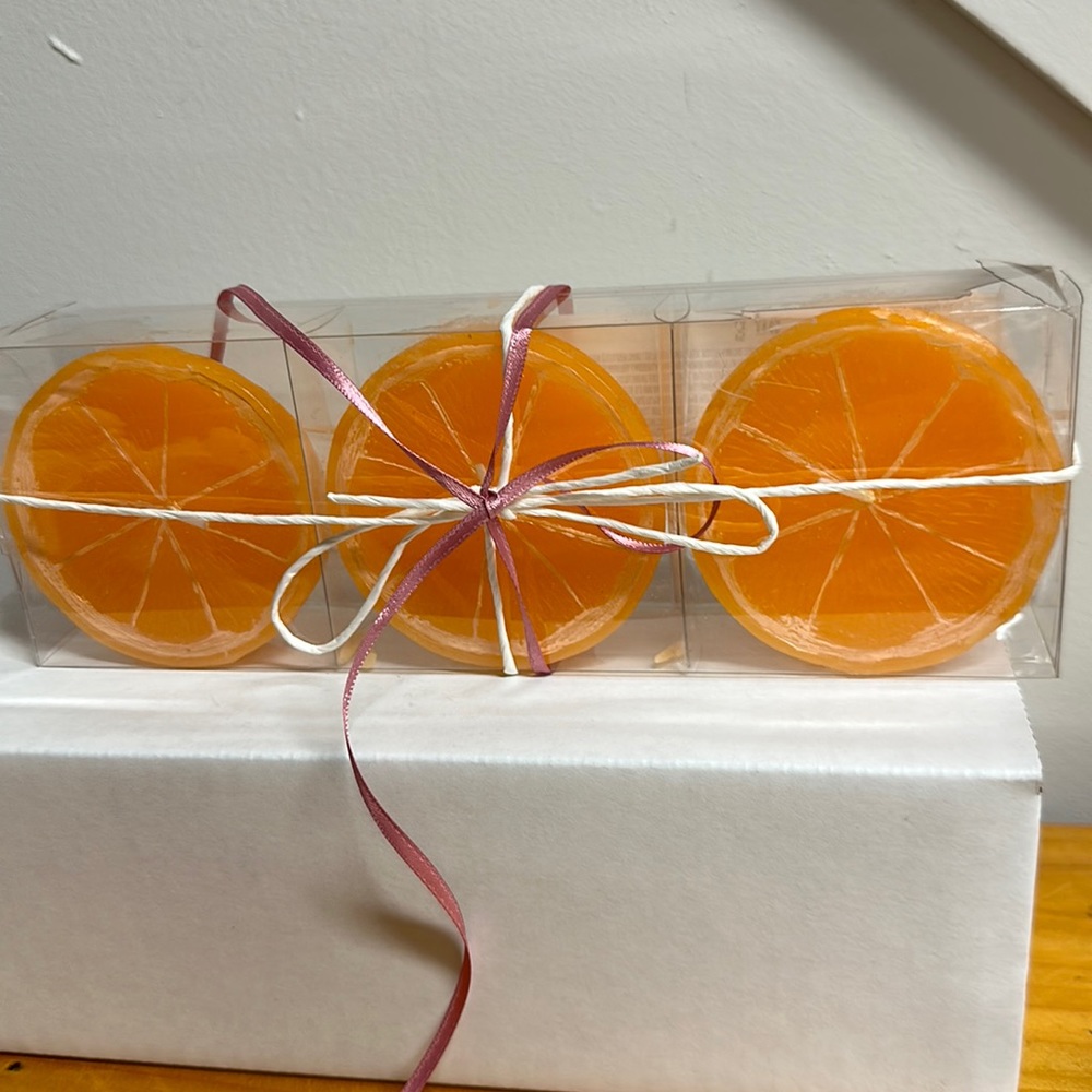 Orange shaped candles new in package . Set includes 3 candles.Unscented